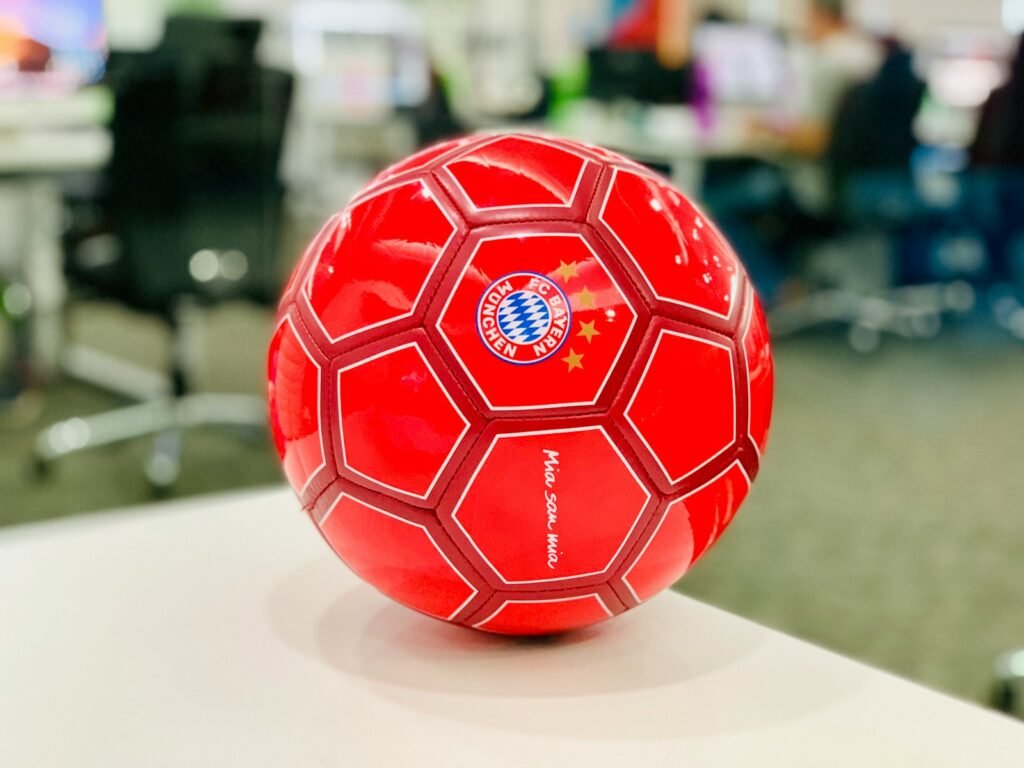 red soccer ball on white table